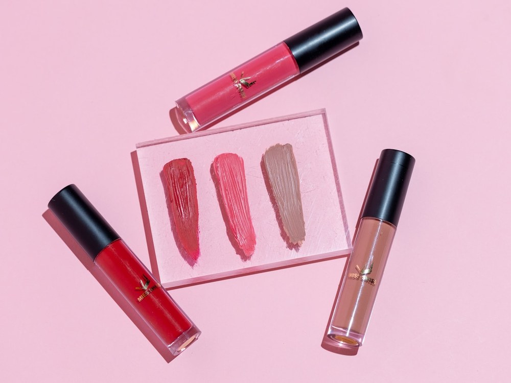 Lipsticks and swatches on pink