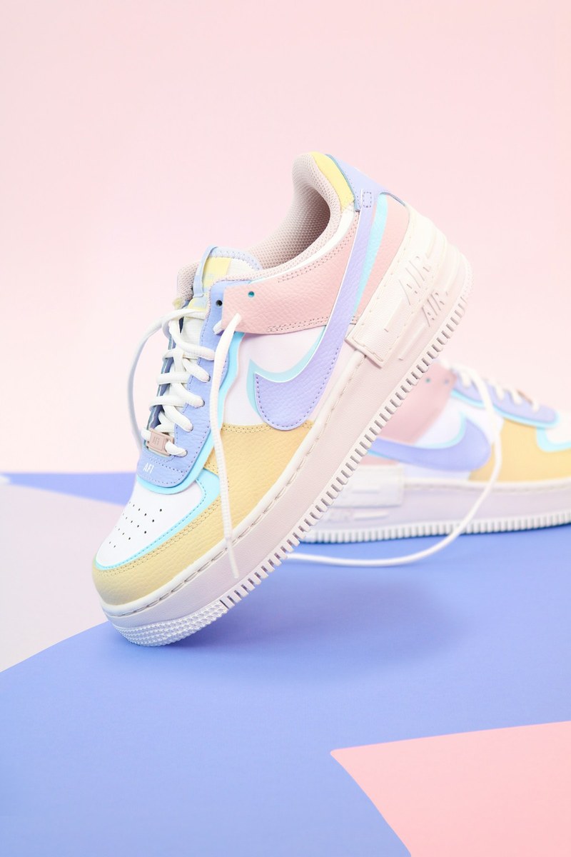 Pastel sneakers on a blue and pink surface
