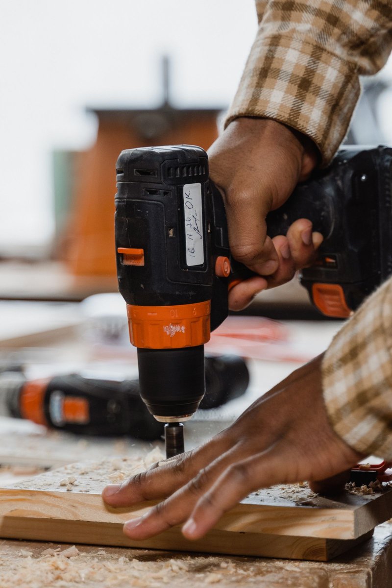 A hand using a cordless drill