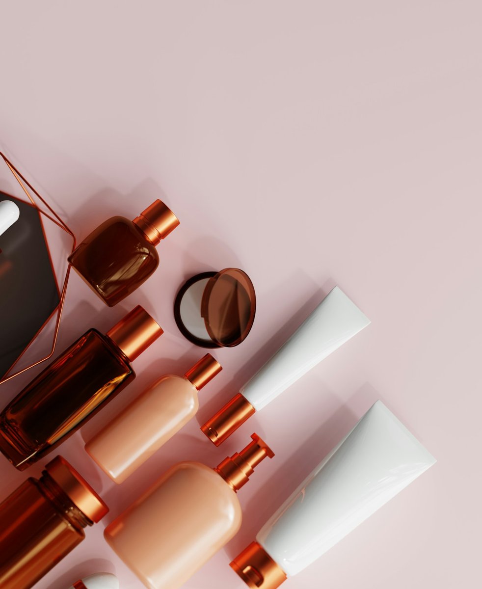 Copper-capped beauty bottles on pink