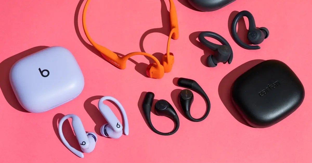 Headphones and earbuds on pink