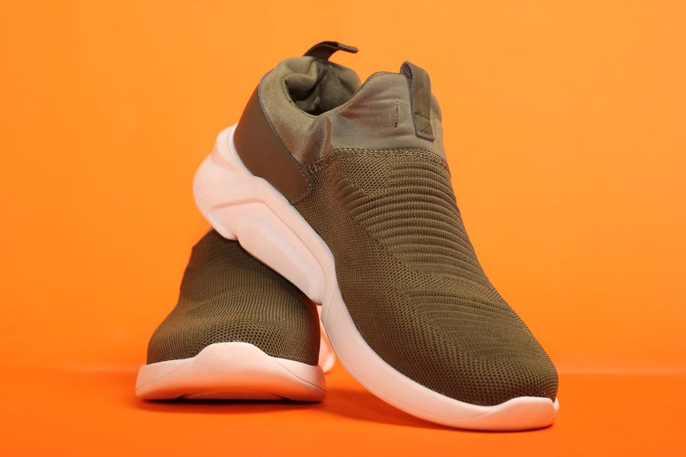Olive sneakers on orange