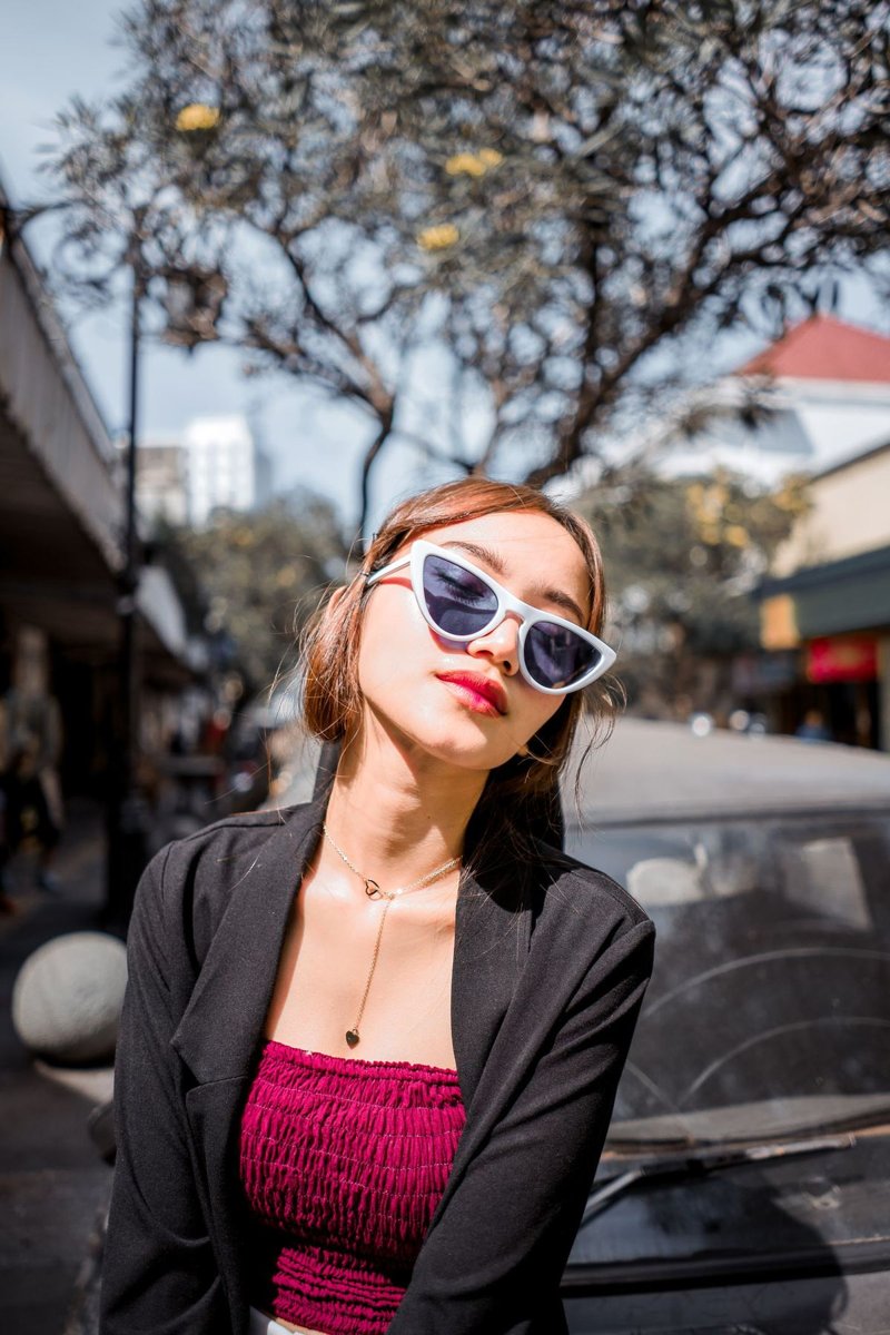 A woman in sunglasses and a black blazer