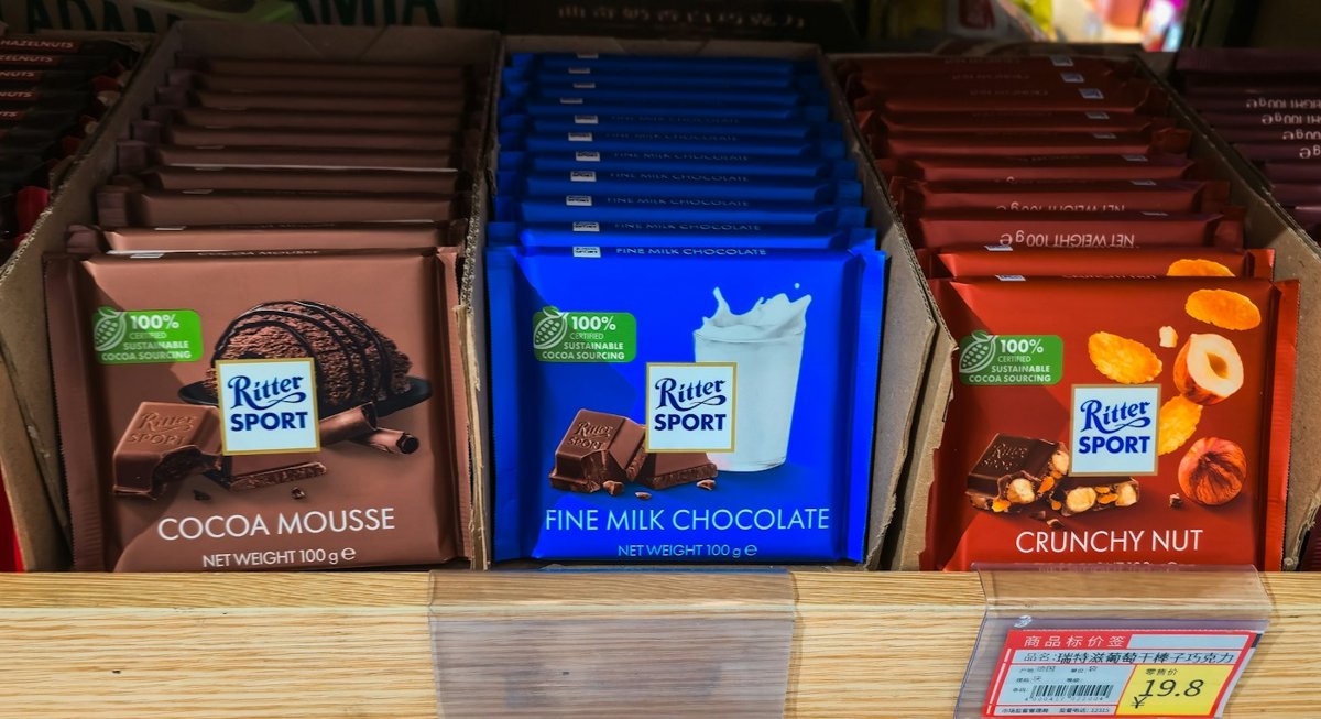 Chocolate bars lined up on a store shelf