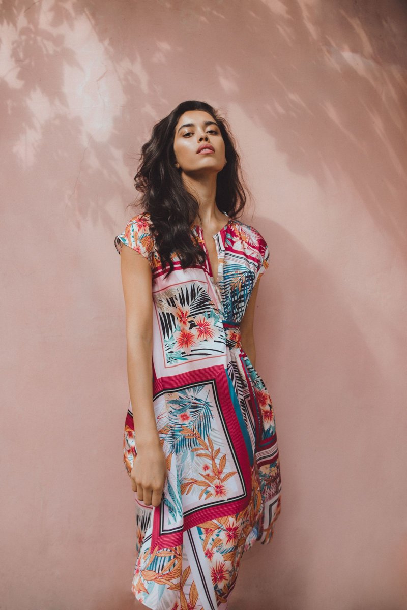 A woman in a floral jumpsuit