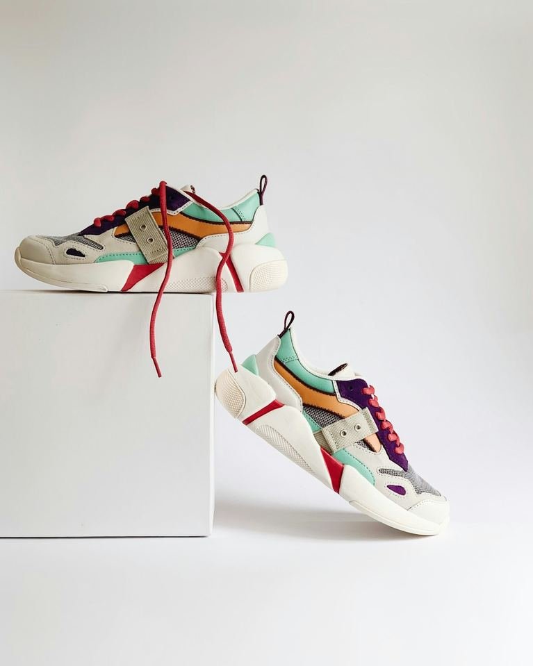 Sneakers with red laces on a white shelf